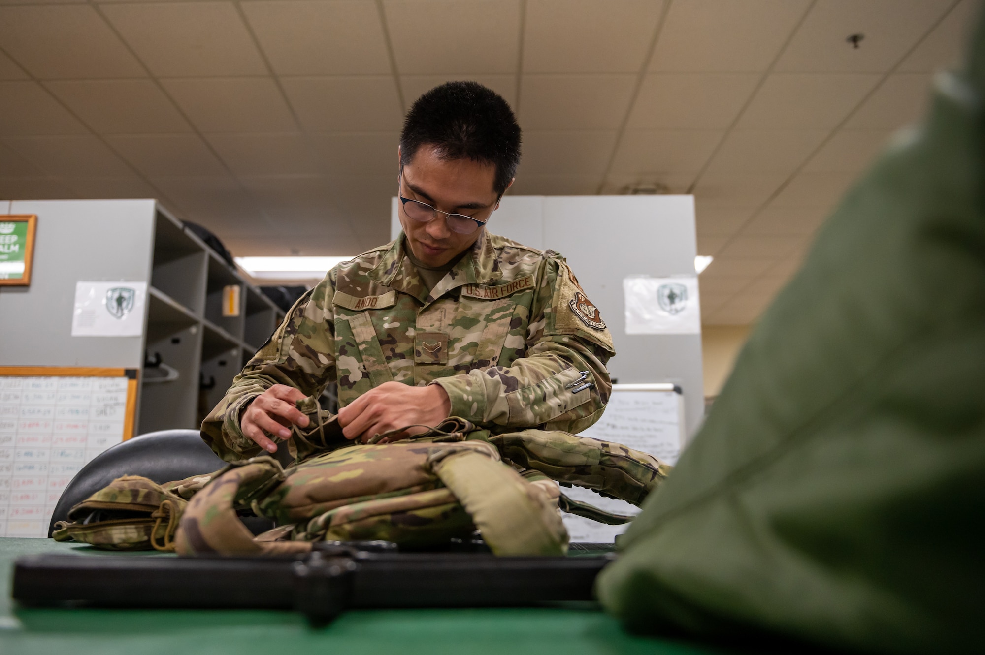 Airman inspecting aircrew equipment