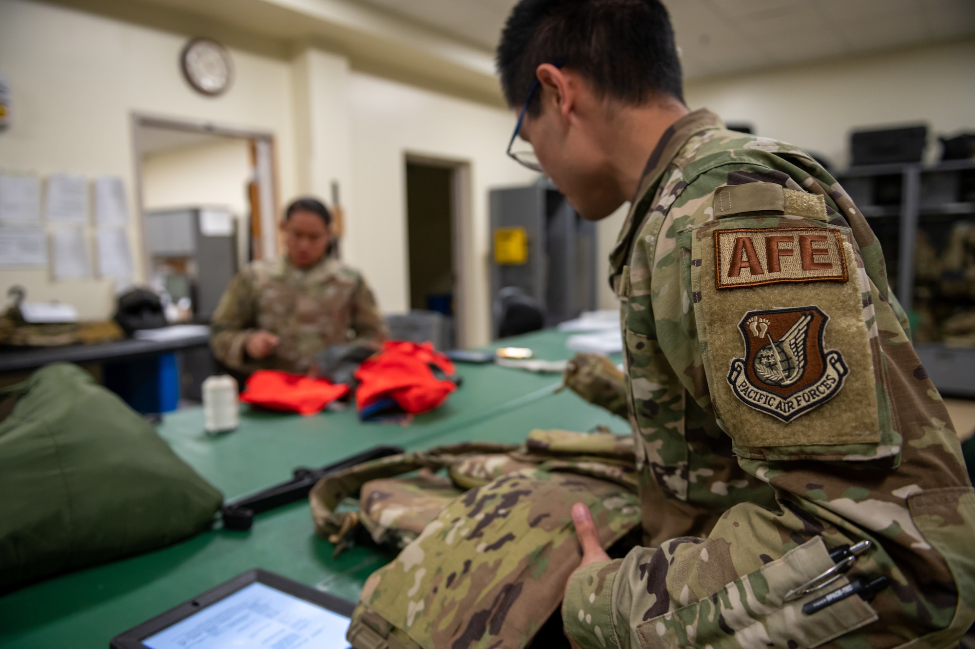 Airmen inspecting aircrew equipment