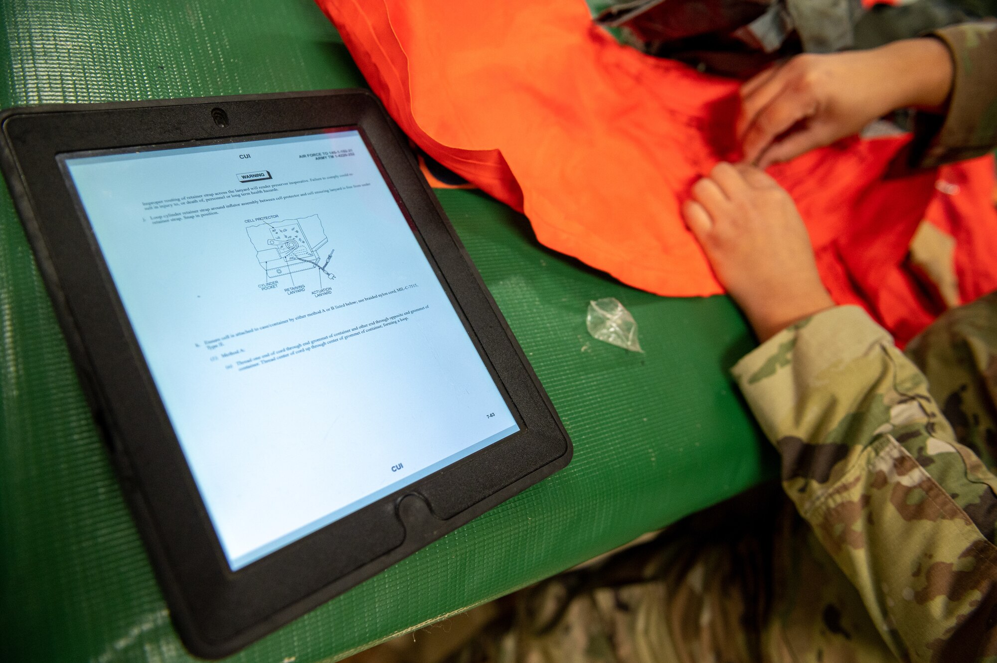 Airman inspecting aircrew equipment