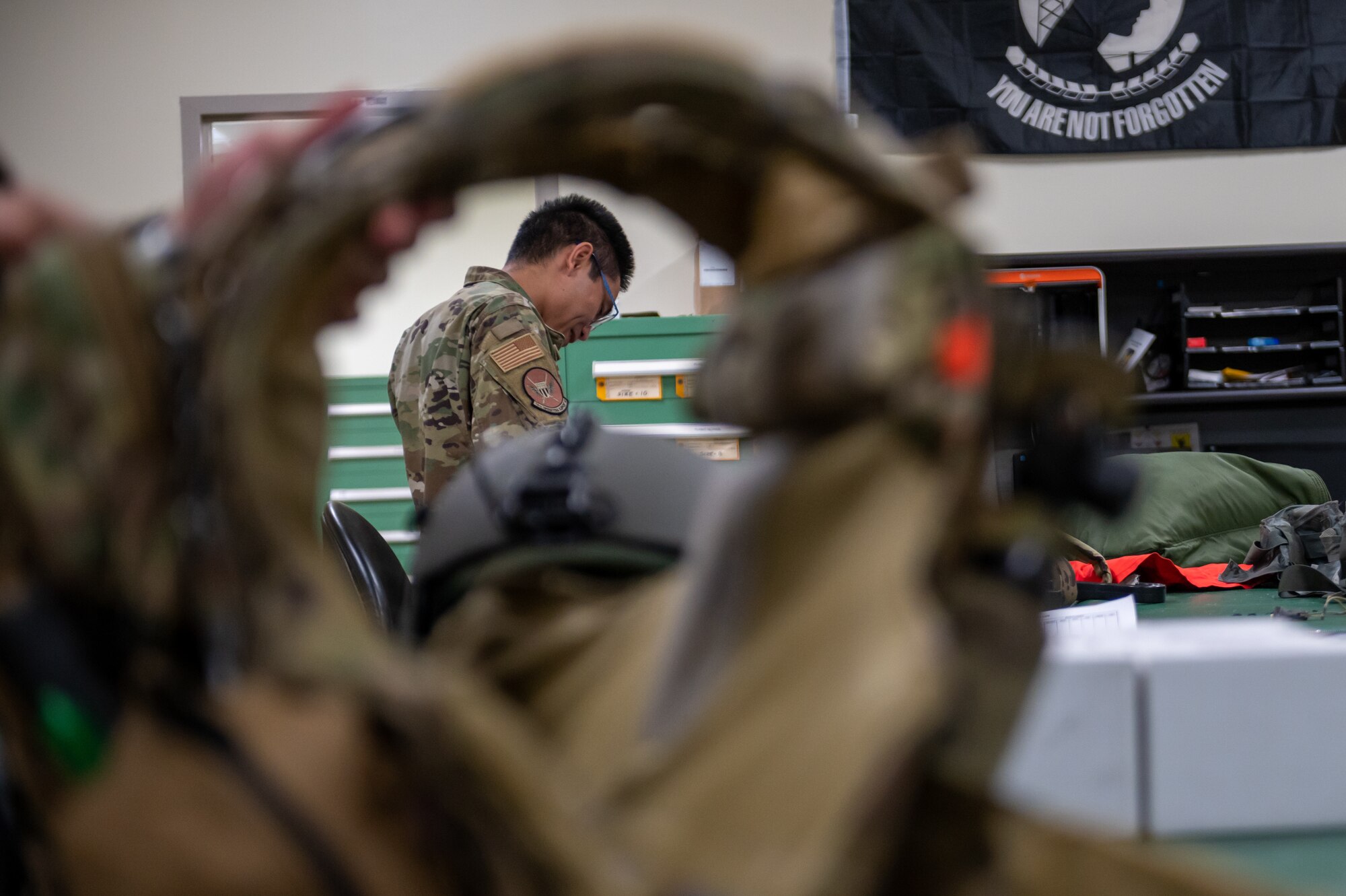 Airman inspecting aircrew equipment