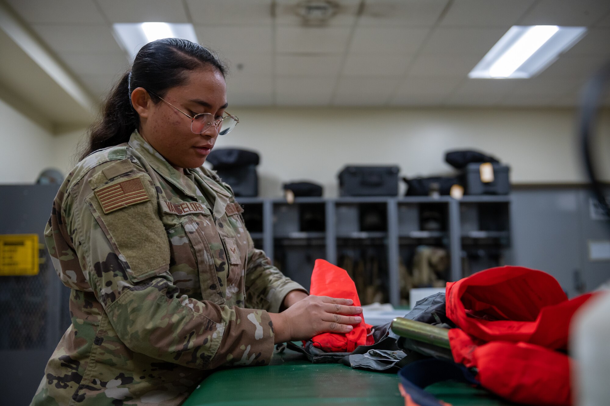 Airman inspecting aircrew equipment