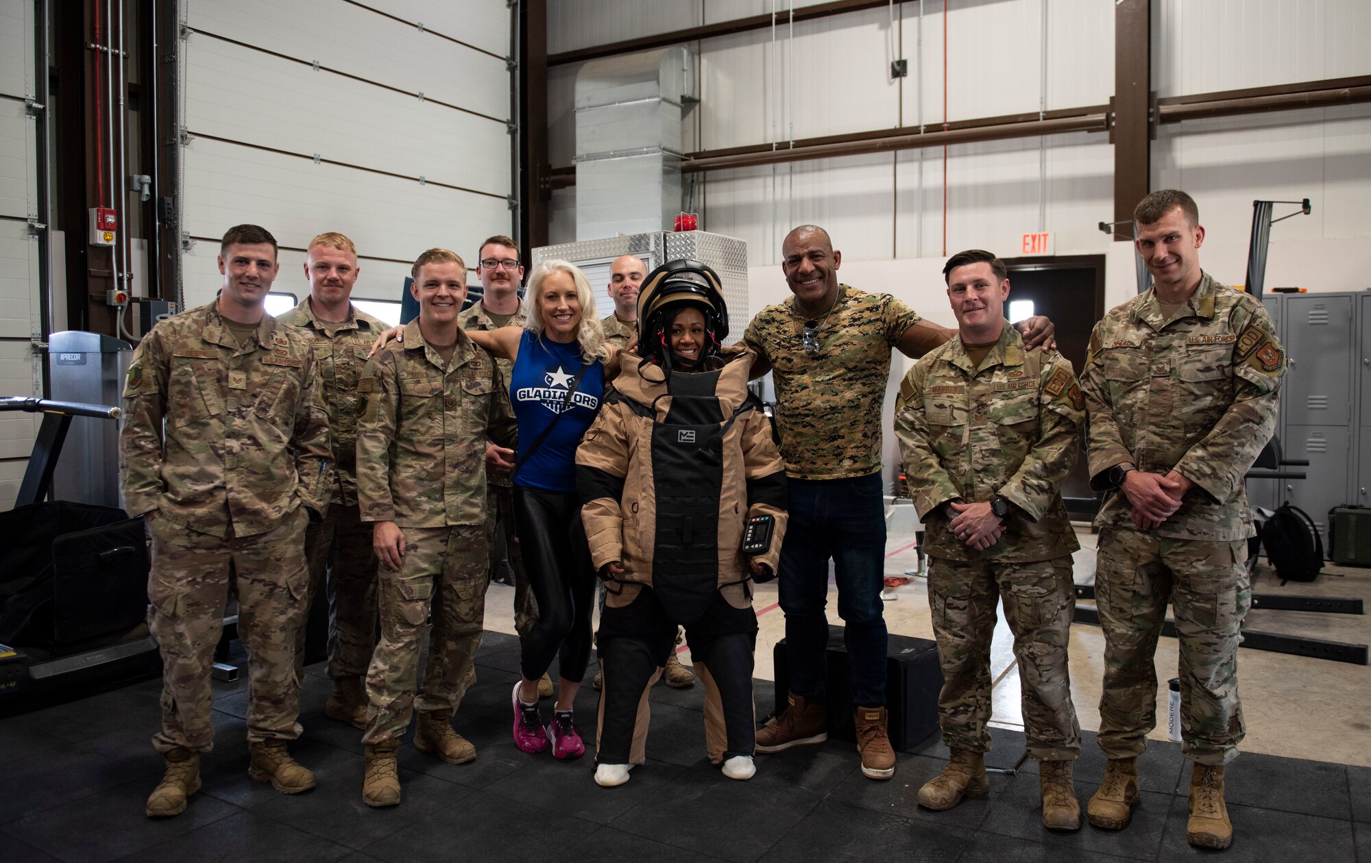 Airmen from the 39th Air Base Wing Civil Engineer Squadron pose for a photo with members of the athletic competition television show, “American Gladiators,” at Incirlik Air Base, Turkey, April 27, 2022. Cast members of “American Gladiators” visited Incirlik AB to show support of base members serving in overseas locations and thank 39 ABW Airmen for their unwavering dedication to defending NATO’s southern flank. (U.S. Air Force photo by Staff Sgt. Gabrielle Winn)