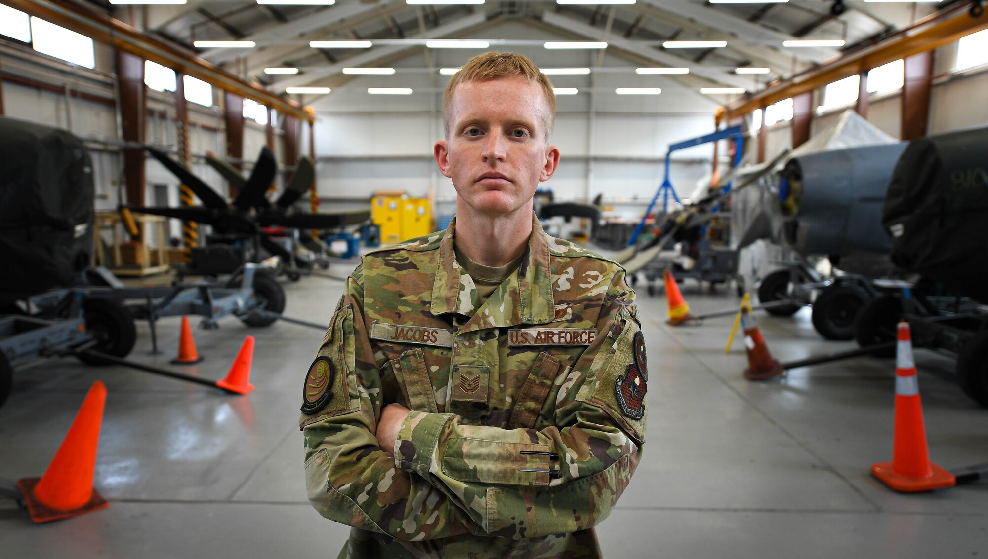 U.S. Air Force Tech. Sgt. Ryley S. Jacobs, 373rd Training Squadron, Detachment 20 instructor supervisor, poses for a photo in a maintenance squadron workshop at Ramstein Air Base, Germany, April 25, 2022. Jacobs was recognized as Airlifter of the Week, April 21, 2022, for his ability to lead and inspire Airmen under difficult circumstances. As an instructor for 86th Maintenance Group Airmen, Jacobs is a subject matter expert in aerospace propulsion, teaching Airmen proper maintenance techniques. (U.S. Air Force photo by Airman 1st Class Jared Lovett)