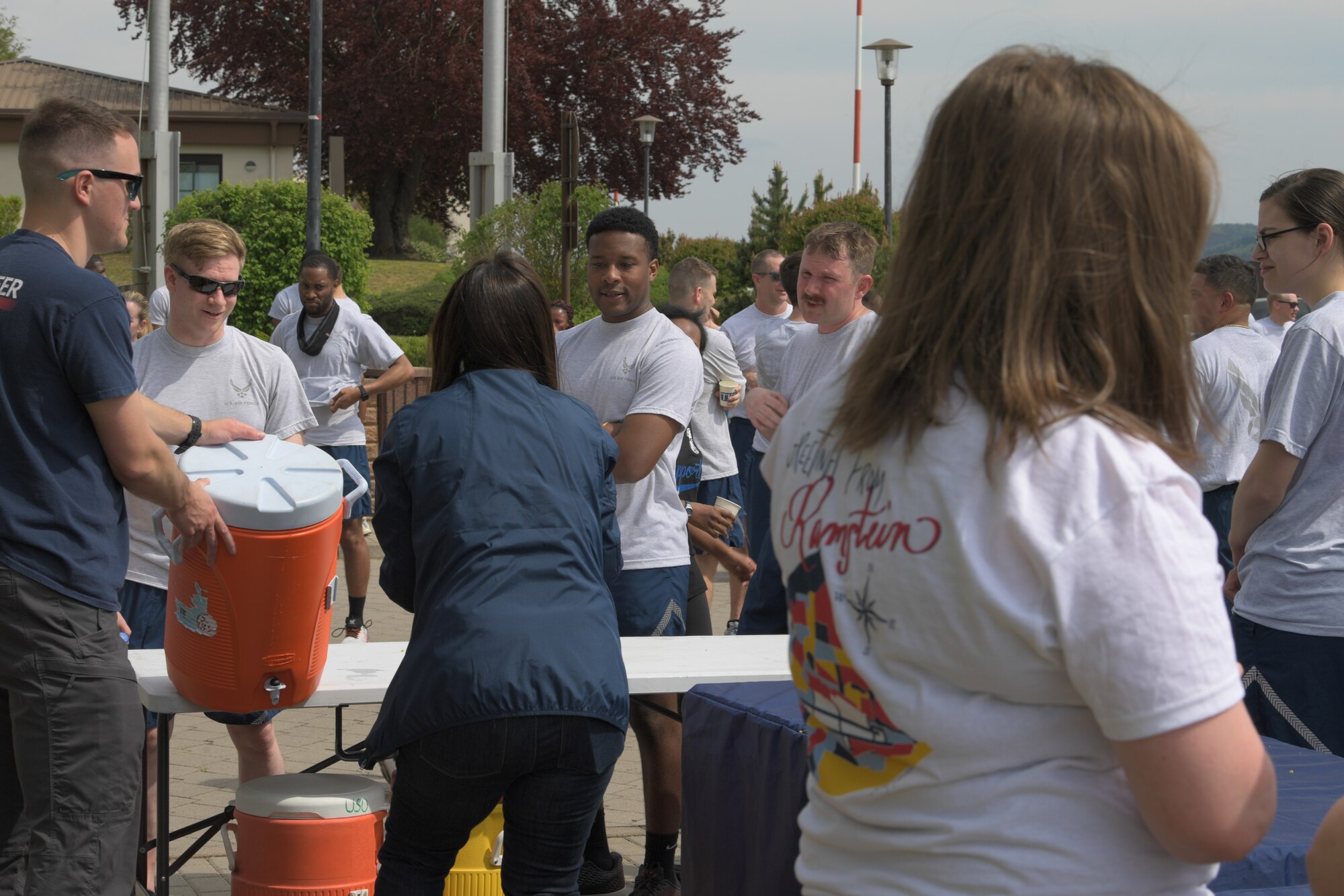 Volunteers pass snacks and water to Airmen