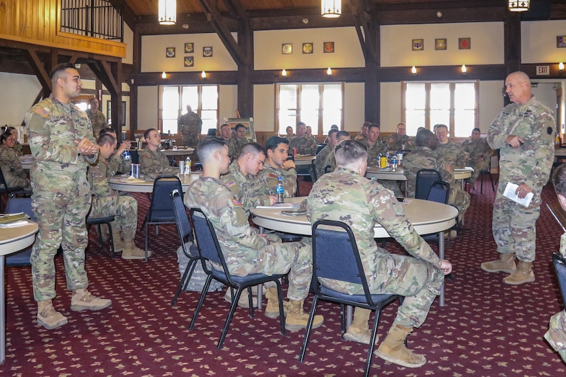During the 28th Infantry Division Iron Lieutenant Leadership Orientation at Fort Indiantown Gap on April 30, Deputy Commanding General for Maneuver Brig. Gen. Michael Wegscheider (standing right) discussed topics of problem-solving, readiness and retention, building strong teams, and work ethic. Second Lt. Andrae Holsey (standing left) of (ATRP, 2-104th CAV) A Troop, 2nd Squadron, 104th Cavalry Regiment answers a question about an alternative solution to a direct fire scenario.