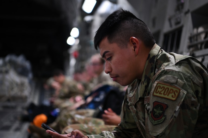 An Airman assigned to the 15th Airlift Squadron awaits deploying to the Middle East aboard a C-17 Globemaster III