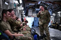 Airmen assigned to the 15th Airlift Squadron await deploying to the Middle East aboard a C-17 Globemaster III