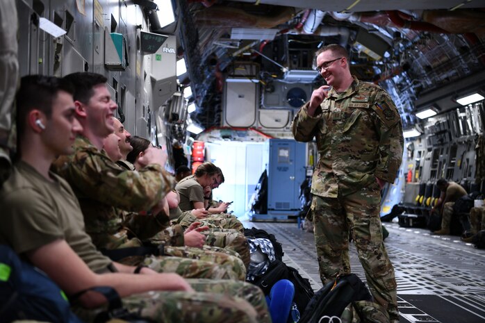 Airmen assigned to the 15th Airlift Squadron await deploying to the Middle East aboard a C-17 Globemaster III