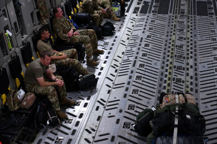 Airmen assigned to the 15th Airlift Squadron await deploying to the Middle East aboard a C-17 Globemaster III