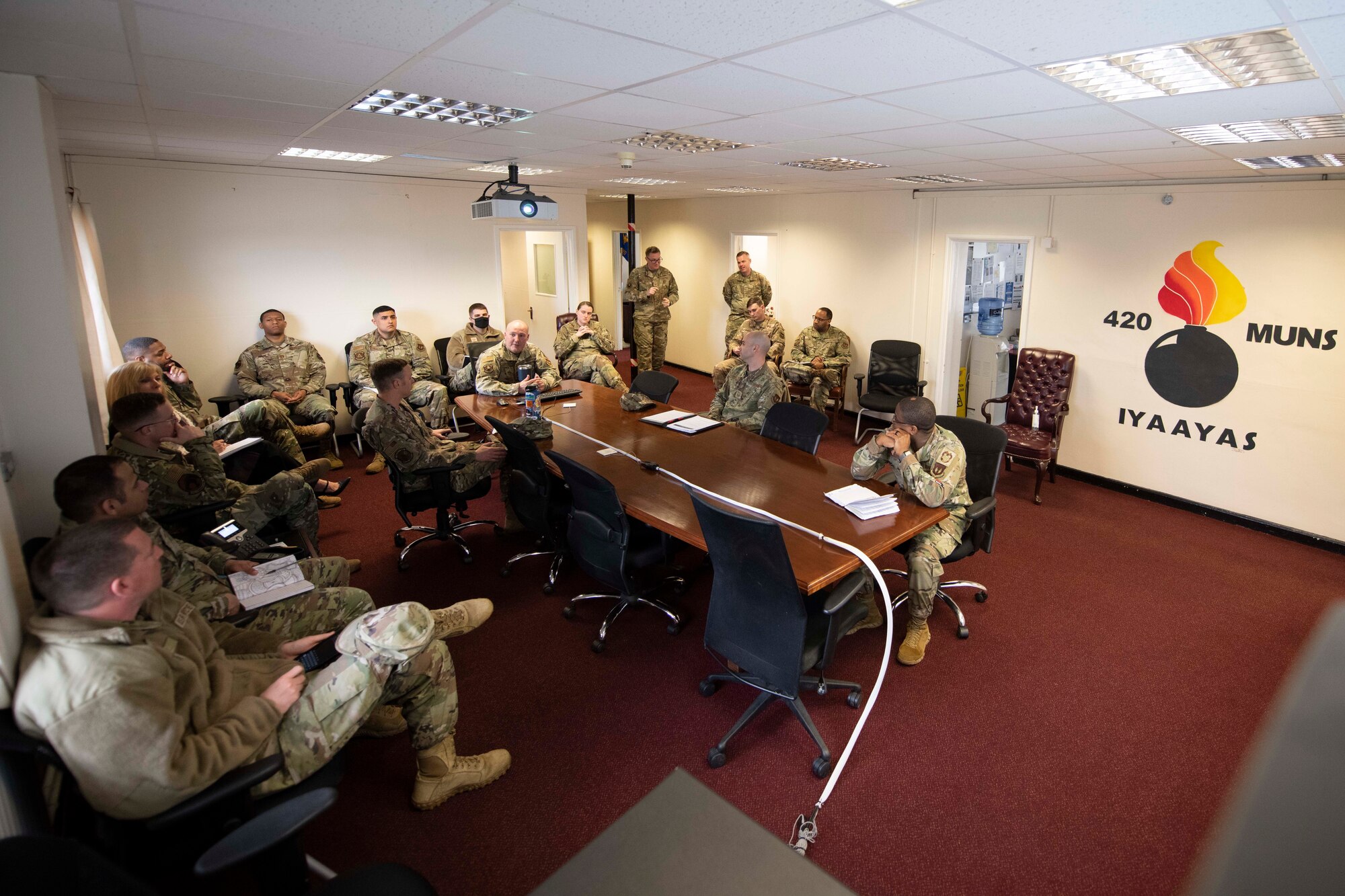 U.S. Air Force Senior Master Sgt. Michael Carvalho, center, 420th Munitions Squadron senior enlisted leader, briefs the 501st Combat Support Wing Readiness Working Group with the missions at Royal Air Force Welford, England, April 27, 2022. The group attended an immersion tour at RAF Welford and RAF Fairford to orient themselves with the missions these bases provide. (U.S. Air Force photo by Senior Airman Jennifer Zima)