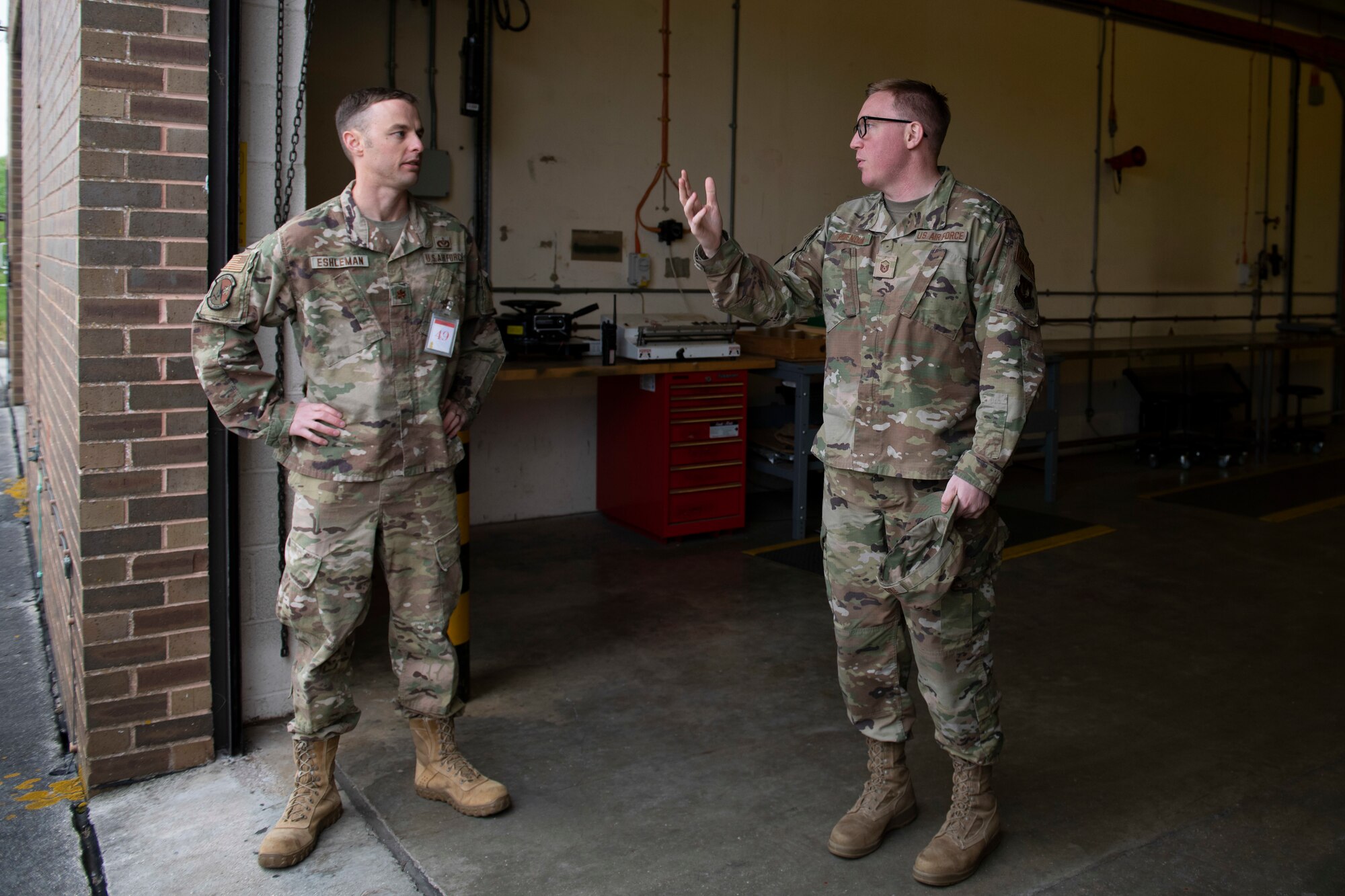 U.S. Air Force Master Sgt. Aaron Ridenour, right, 420th Munitions Squadron production flight chief, talks with Maj. Justin Eshleman, left, 423rd Civil Engineer Squadron special projects officer, at Royal Air Force Welford, England, April 27, 2022. The group attended an immersion tour at RAF Welford and RAF Fairford to orient themselves with the missions these bases provide. (U.S. Air Force photo by Senior Airman Jennifer Zima)