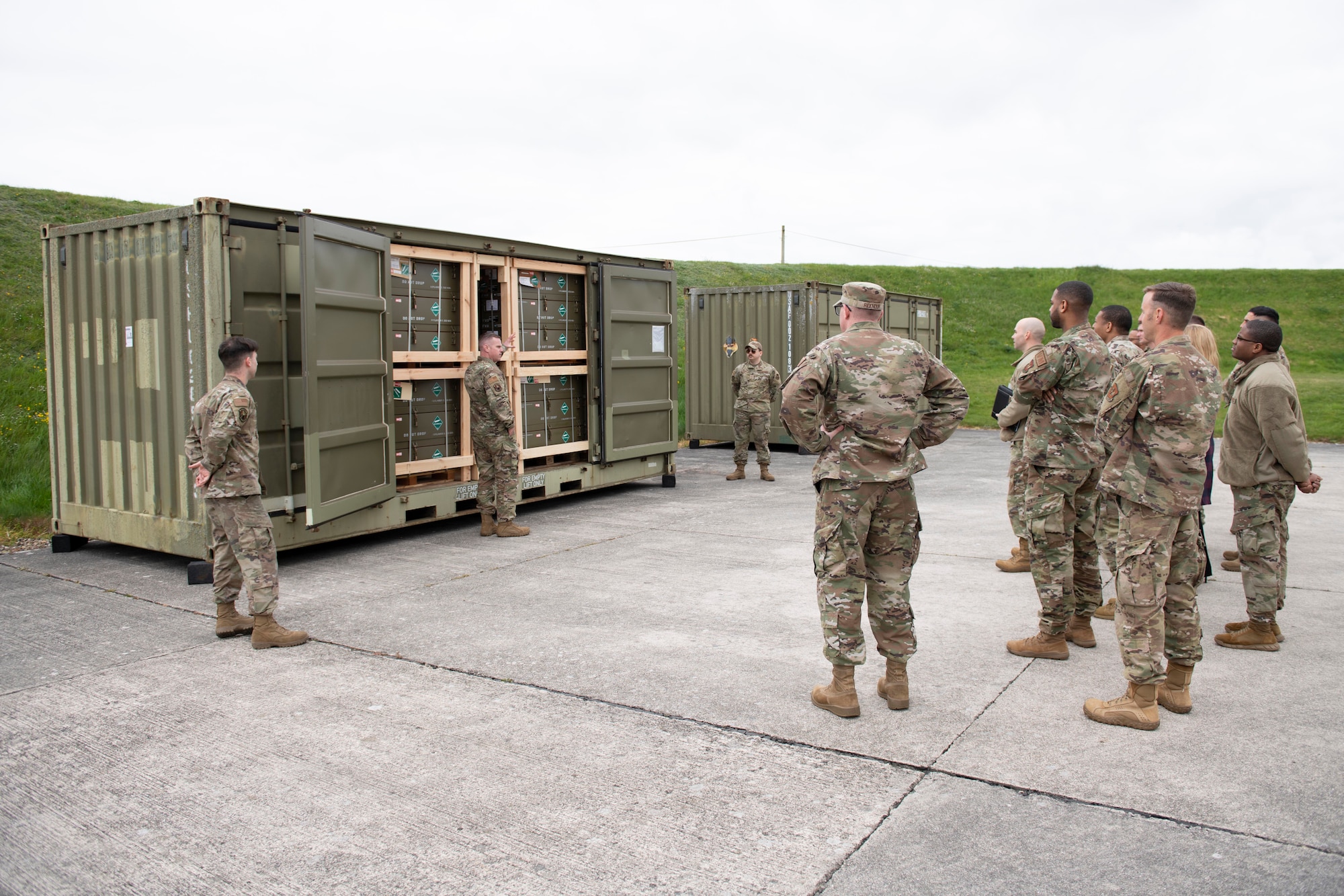 U.S. Air Force Master Sgt. Stephen Ball, center, 420th Munitions Squadron systems flight chief, briefs the 501st Combat Support Wing Readiness Working Group with the munitions inspection area at Royal Air Force Welford, England, April 27, 2022. The group attended an immersion tour at RAF Welford and RAF Fairford to orient themselves with the missions these bases provide. (U.S. Air Force photo by Senior Airman Jennifer Zima)