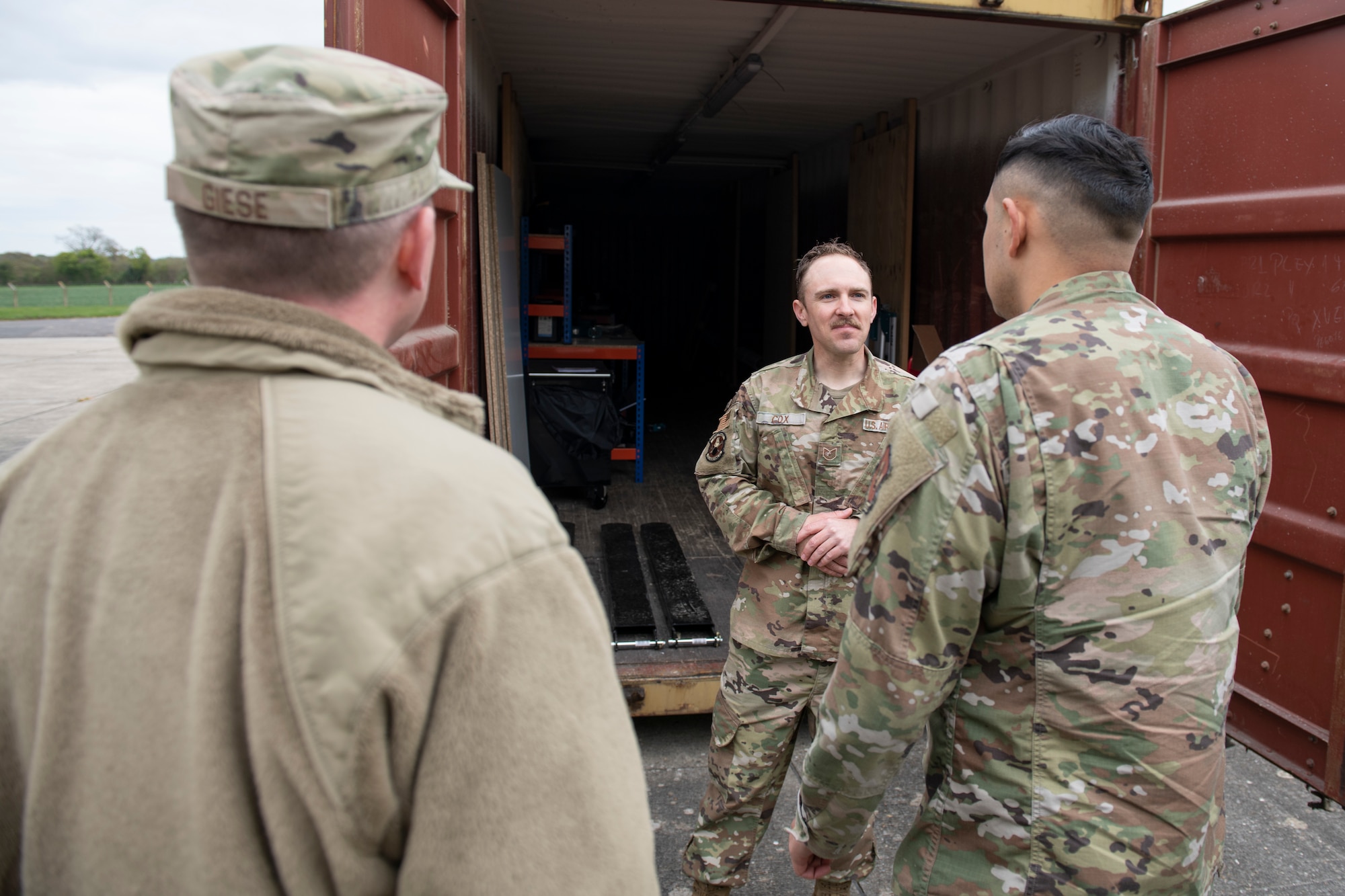 U.S. Air Force Tech. Sgt. Spenser Cox, center, 420th Munitions Squadron noncommissioned officer in charge of conventional maintenance, briefs the 501st Combat Support Wing Readiness Working Group at the munitions wood handling facility at Royal Air Force Welford, England, April 27, 2022. The group attended an immersion tour at RAF Welford and RAF Fairford to orient themselves with the missions these bases provide. (U.S. Air Force photo by Senior Airman Jennifer Zima)