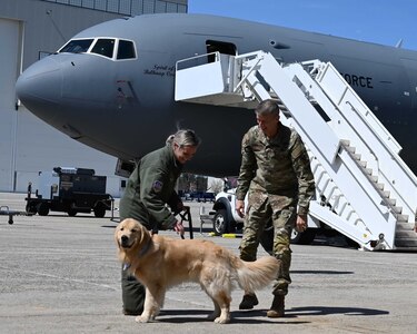 Tech. Sgt. Natalie Belongie, a boom operator with the 157th Air Refueling Wing, introduces Wing mascot "Pack" to visiting Gen. David Hokanson, chief, National Guard Bureau, on May 3, 2022, at Pease Air National Guard Base in Newington.