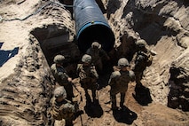U.S. Marines with Engineer Support Company, 8th Engineer Support Battalion, dig a trench for the construction of an underground bunker during a field exercise at Camp Lejeune, North Carolina, April 26, 2022. Engineer Support Company conducted a field exercise in order to increase readiness while providing tactical utilities and heavy equipment support in an urban terrain environment.