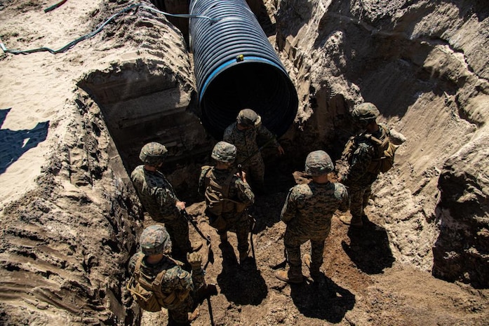 U.S. Marines with Engineer Support Company, 8th Engineer Support Battalion, dig a trench for the construction of an underground bunker during a field exercise at Camp Lejeune, North Carolina, April 26, 2022. Engineer Support Company conducted a field exercise in order to increase readiness while providing tactical utilities and heavy equipment support in an urban terrain environment.