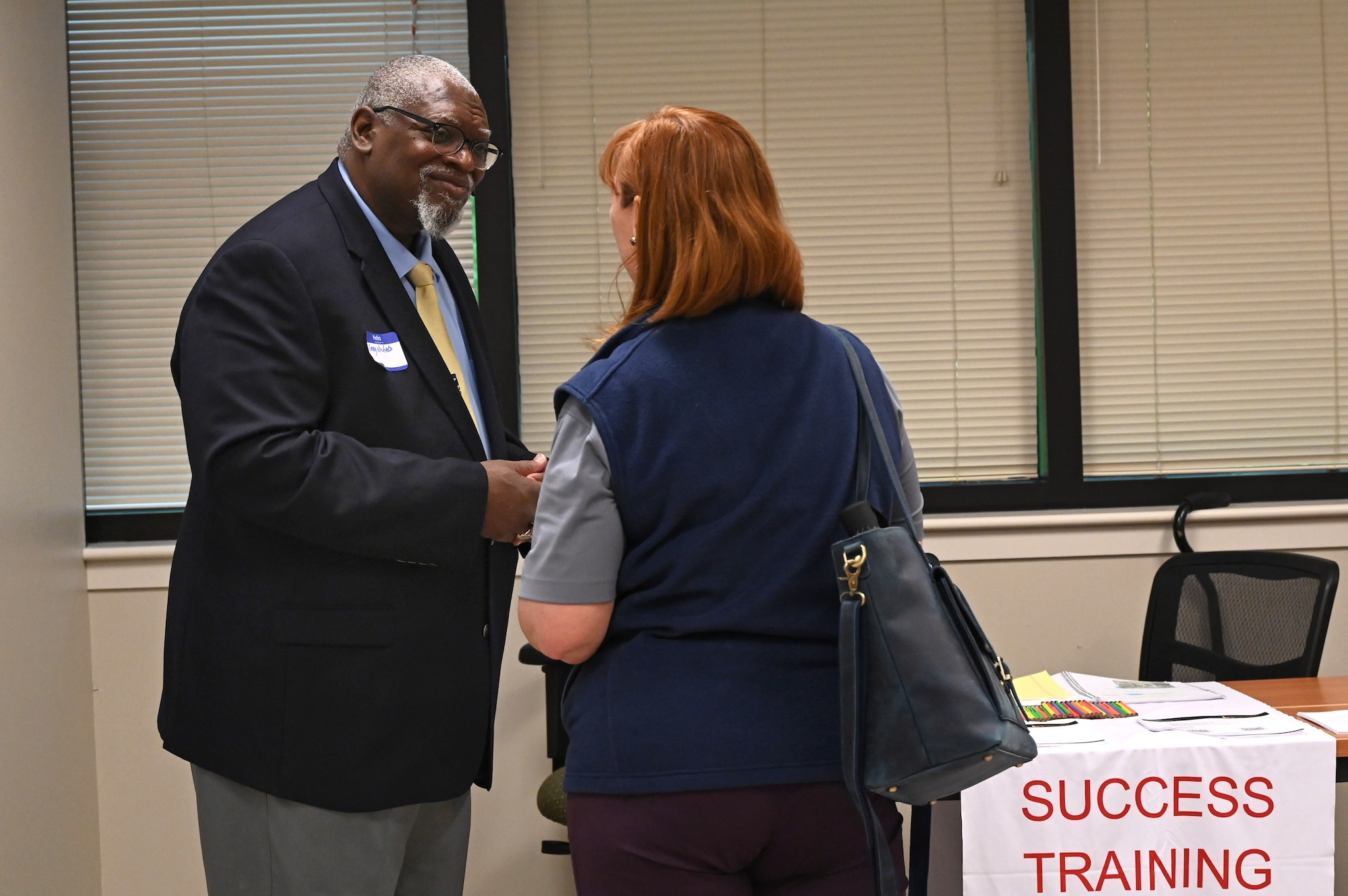 A member of Team Little Rock speaks with a local business vendor during a vendor fair and pitch day event