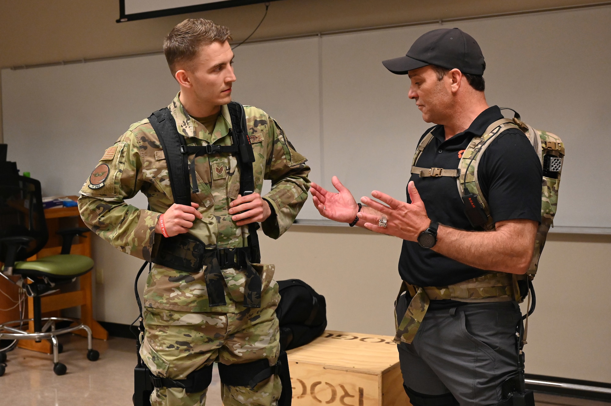 An Airman assigned to the 19th Airlift Wing dons a robotic system prototype during a vendor fair and pitch day event