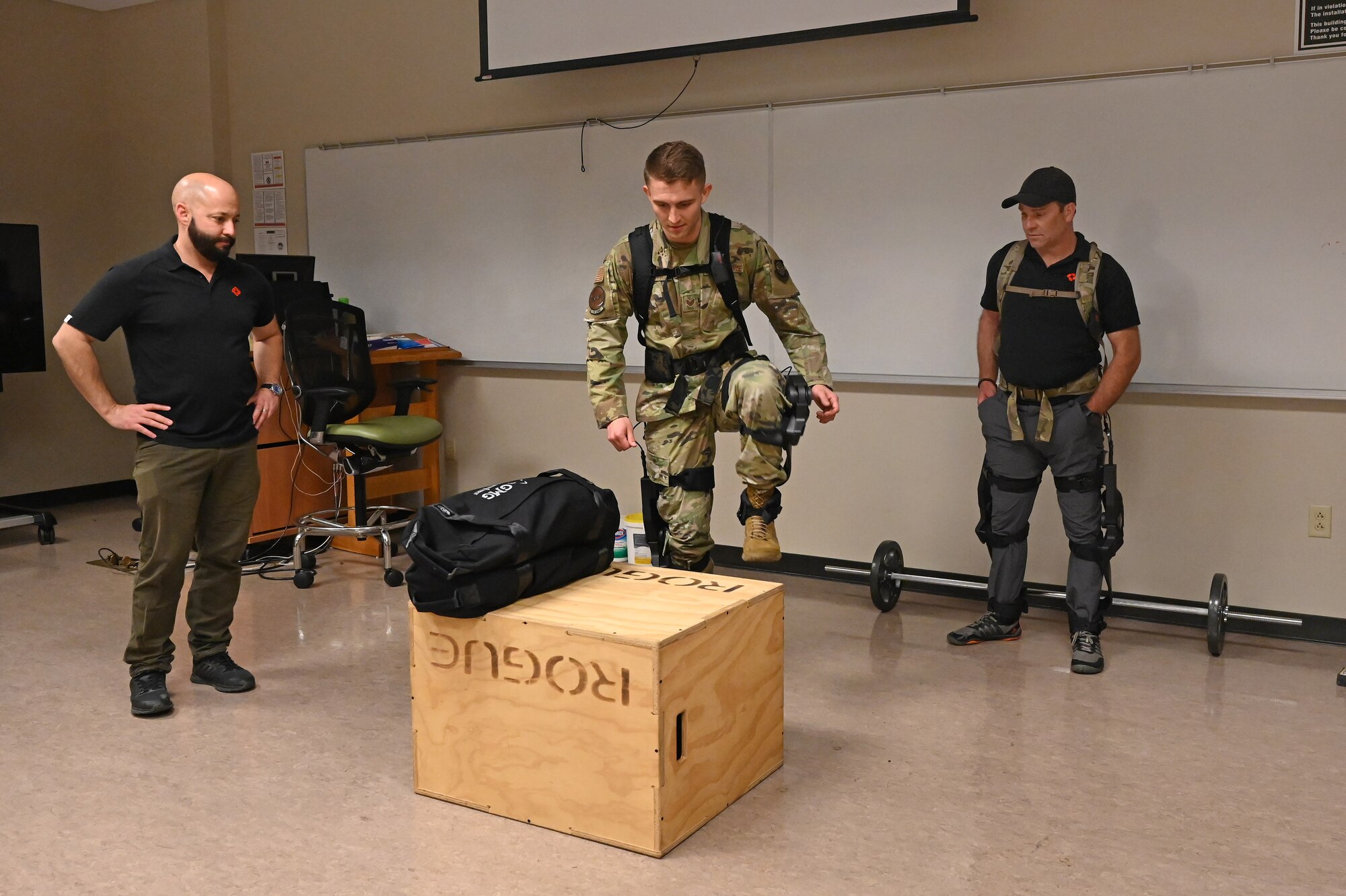 An Airman assigned to the 19th Airlift Wing dons a robotic system prototype during a vendor fair and pitch day event