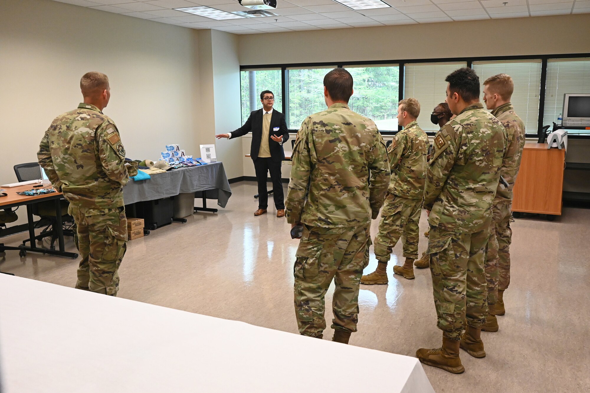 Airmen assigned to the 19th Airlift Wing speak with a local business vendor during a vendor fair and pitch day event