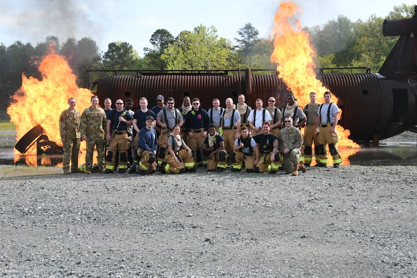 Members from the 316th Civil Engineer Squadron and 193rd Special Operations Wing pose for a group photo at a live fire-fighting training at Joint Base Andrews, Md., May 2, 2022.