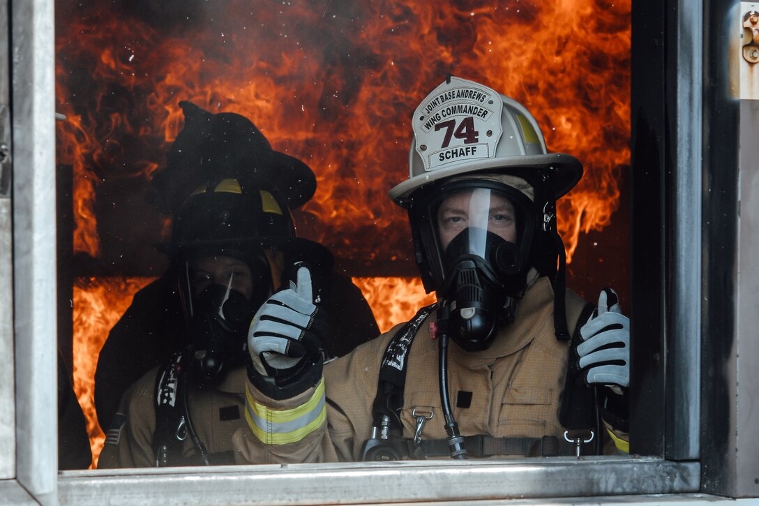 Col. Tyler Schaff, 316th Wing and installation commander, right, poses for a photo during an interagency fire-fight training at Joint Base Andrews, Md., May 2, 2022.