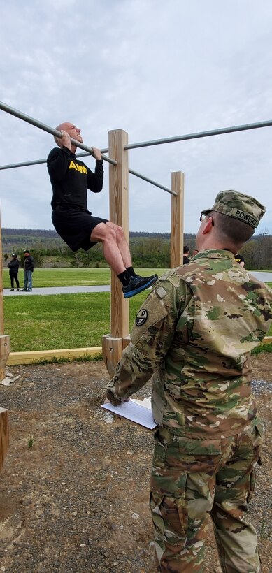 A competitor executes a flex-arm hang during the German Armed Forces Proficiency Badge test event at Fort Indiantown Gap, Pa. on May 1, 2022. The test, ran by the 94th Training Division, 80th Training Command's Regional Training Site-Maintenance here, lasted three days and included a pistol competition, a 12-kilometer ruck march, and fitness and swimming events.