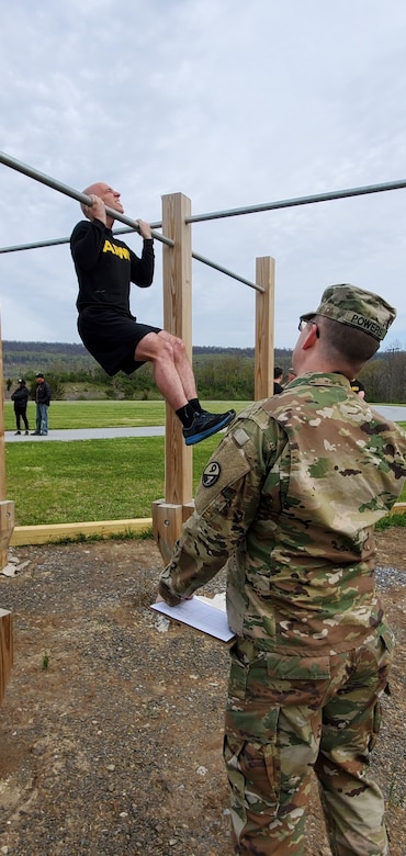 A competitor executes a flex-arm hang during the German Armed Forces Proficiency Badge test event at Fort Indiantown Gap, Pa. on May 1, 2022. The test, ran by the 94th Training Division, 80th Training Command's Regional Training Site-Maintenance here, lasted three days and included a pistol competition, a 12-kilometer ruck march, and fitness and swimming events.