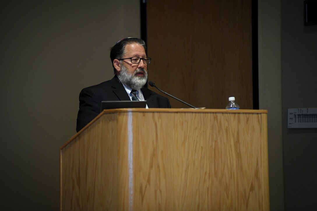 Rabbi stands at podium