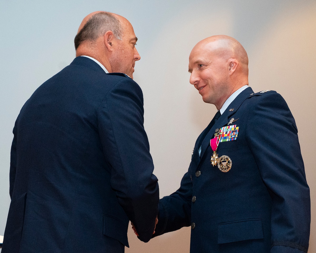 Col. Patrick Miller (left), 88th Air Base Wingand installation commander, congratulatesCol. Ivan Herwick, 88th CommunicationsGroup commander, after presenting himwith the Legion of Merit medal during theunit’s inactivation ceremony April 29, 2022,at Wright-Patterson Air Force Base, Ohio.Herwick was honored for his exceptionallymeritorious conduct in the performance ofoutstanding services as 88 CG’s lastcommander. (U.S. Air Force photo by R.J.Oriez)