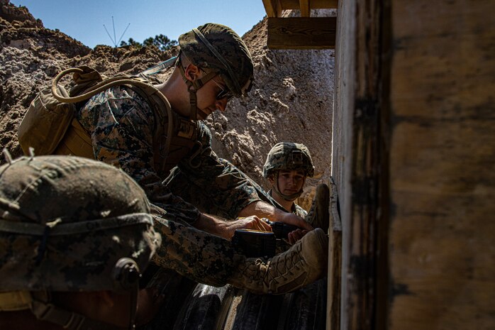 U.S. Marine Corps Cpl. Luke Beverland, a combat engineer with Engineer Support Company, 8th Engineer Support Battalion, attaches a pipe to an underground bunker during a field exercise at Camp Lejeune, N.C., April 26, 2022. Engineer Support Company conducted a field exercise in order to increase readiness while providing tactical utilities and heavy equipment support in an urban terrain environment.