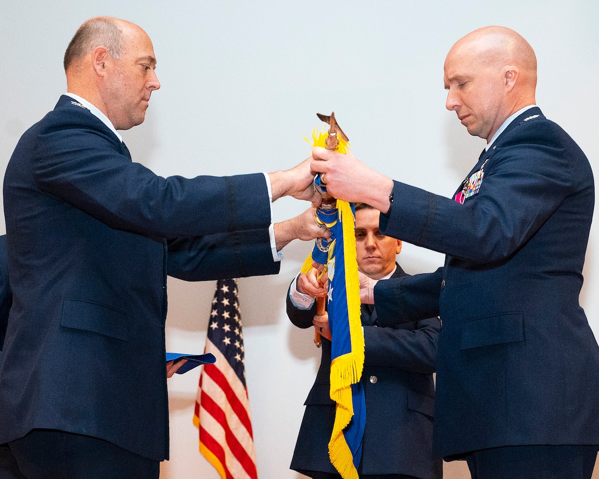 Col. Patrick Miller (left), 88th Air Base Wingand installation commander, and Col. IvanHerwick, 88th Communications Groupcommander, furls the 88 CG guidon, markingthe unit’s inactivation during a ceremonyApril 29, 2022, at Wright-Patterson Air ForceBase, Ohio. The group’s two squadrons wereredesignated under other 88 ABW agenciesas part of a reorganization. (U.S. Air Forcephoto by R.J. Oriez)