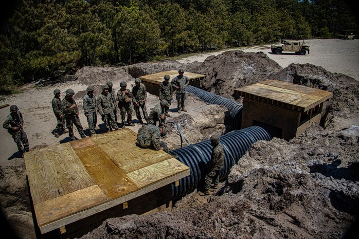 U.S. Marines with Engineer Support Company, 8th Engineer Support Battalion, complete the construction of underground bunkers during a field exercise at Camp Lejeune, N.C., April 26, 2022. Engineer Support Company conducted a field exercise in order to increase readiness while providing tactical utilities and heavy equipment support in an urban terrain environment.
