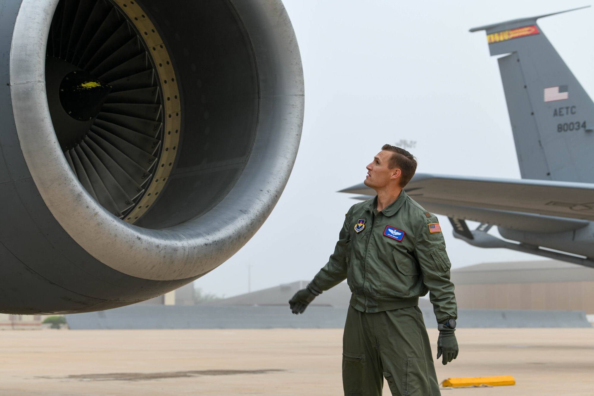 U.S. Air Force Maj. Kevin Bishop, 54th Air Refueling Squadron KC-135 Stratotanker instructor pilot, performs an external inspection of a KC-135 on the flight line during a severe weather flyaway at Altus Air Force Base, Oklahoma, May 4, 2022. Weather predictions forecasted a 50-percent chance of 1.5-inch hail and wind up to 60 knots which could result in extensive damage to the aircraft. (U.S. Air Force photo by Airman 1st Class Trenton Jancze)