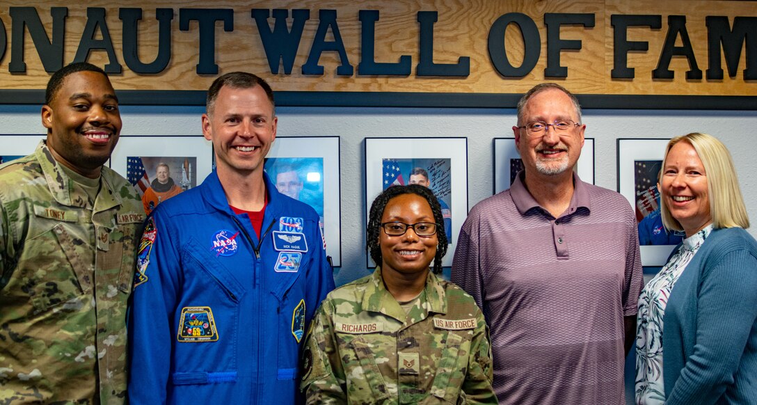 Airmen, NASA Astronaut and civilians pose for a photo