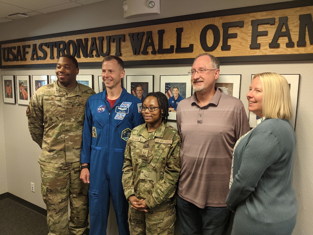 Airmen, NASA Astronaut, and civilians all pose for a photo