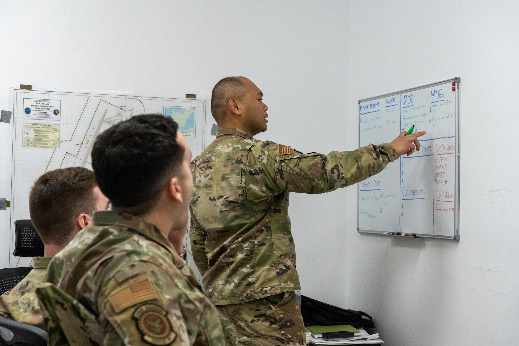 First Lt. John Paul Fernandez, 22nd Communications Squadron Mission Defense Team officer in charge, leads a planning session for a network surveillance mission March 23, 2022, at Morón Air Base, Spain. In these missions, Airmen monitor their assigned networks for malicious actions to establish a baseline of regular activity or identify threats. (U.S. Air Force photo by Staff Sgt. Nathan Eckert)