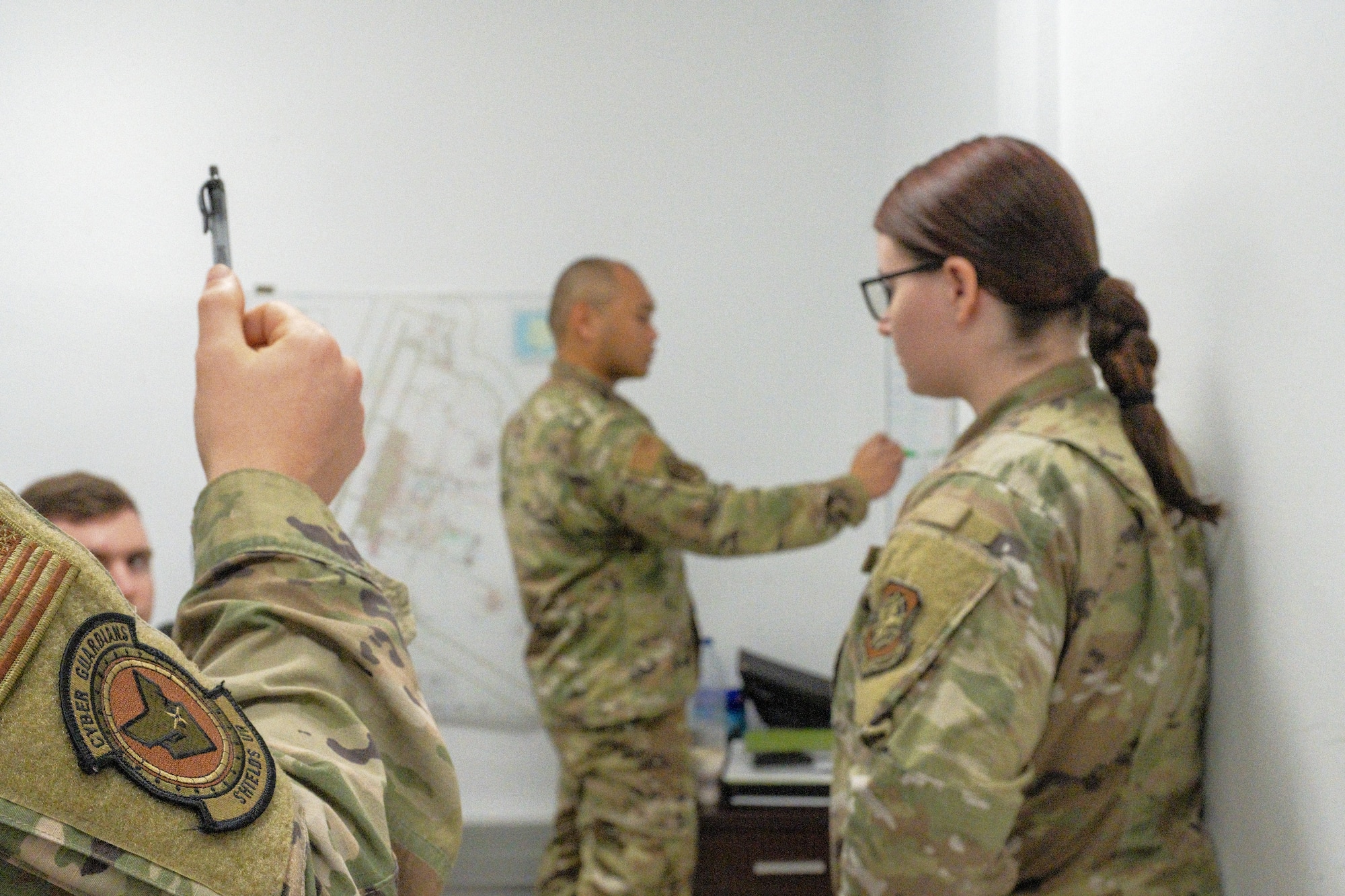 McConnell’s Mission Defense Team members discuss strategy for an upcoming network surveillance mission March 23, 2022, at Morón Air Base, Spain. The MDT is charged with protecting the systems directly associated with KC-46A Pegasus mission generation and execution. (U.S. Air Force photo by Staff Sgt. Nathan Eckert)