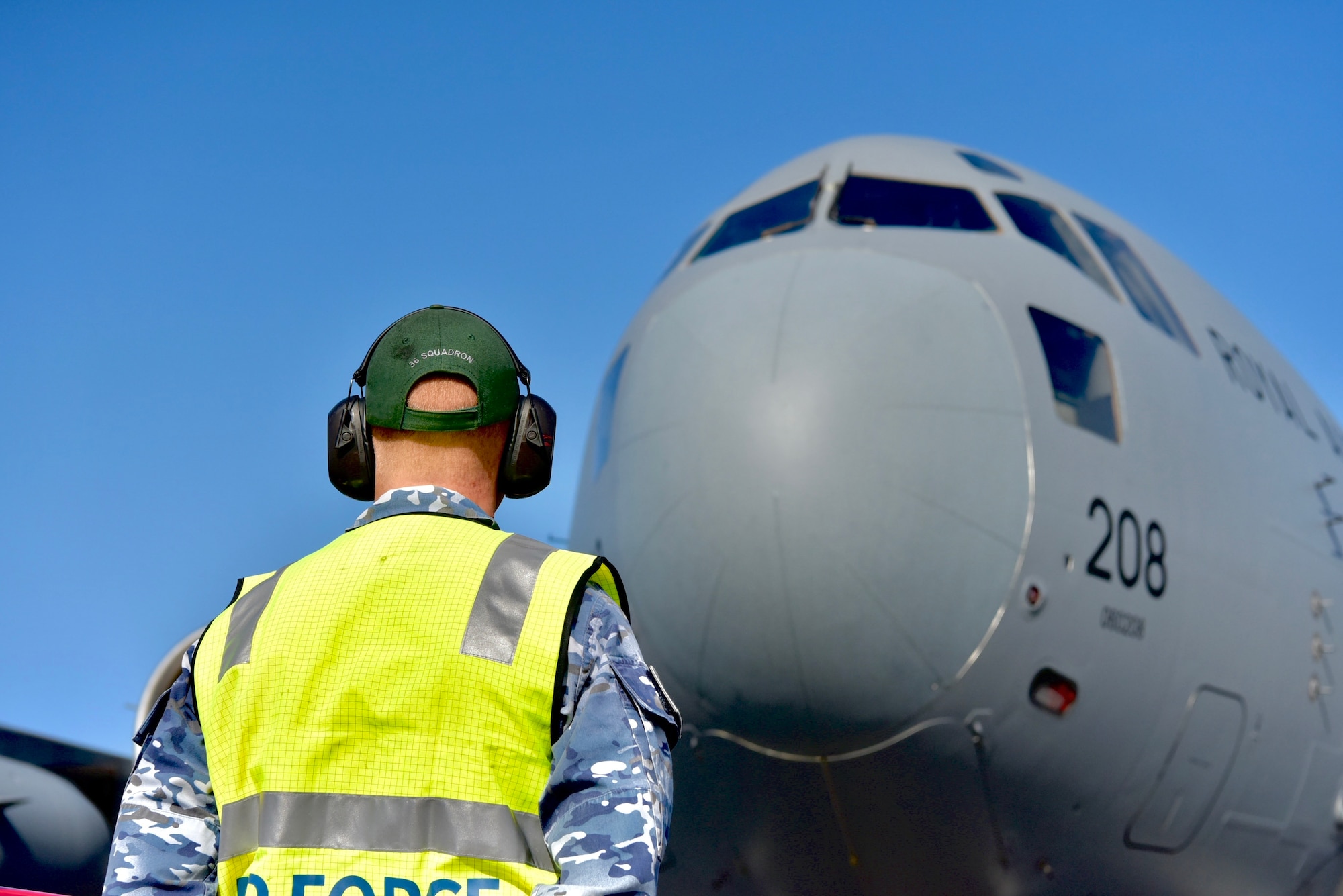 Royal Australian Air Force Leading Aircraftman Luke McAndrew, No. 36 Squadron aircraft technician, listens over the radio during the pre-flight inspection of a C-17 Globemaster III before taking off at Joint Base Pearl Harbor-Hickam, Hawaii, May 3, 2022. The RAF joined the 535th Airlift Squadron for low level flying exercises around the Hawaiian Islands to better increase each crew’s operational resiliency. (U.S. Air Force photo by 1st Lt. Benjamin Aronson)