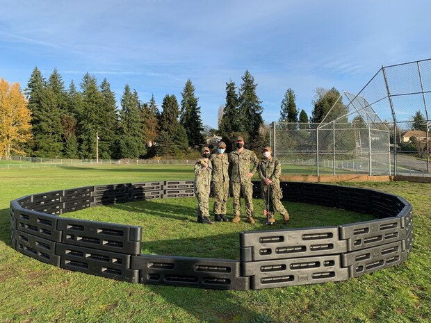 BREMERTON, Wash. (Nov. 17, 2021) Sailors assigned to the to the Ohio-class nuclear-powered guided missile submarine USS Michigan (SSGN 727) pose for a photo around playground equipment they helped build at West Hills STEM Academy. Their volunteer efforts were part of the "Partnerships in Education" program, where Navy commands partner with local schools to connect with their community while earning volunteer hours. (U.S. Navy photo by Rebecca McLenithan/Released)