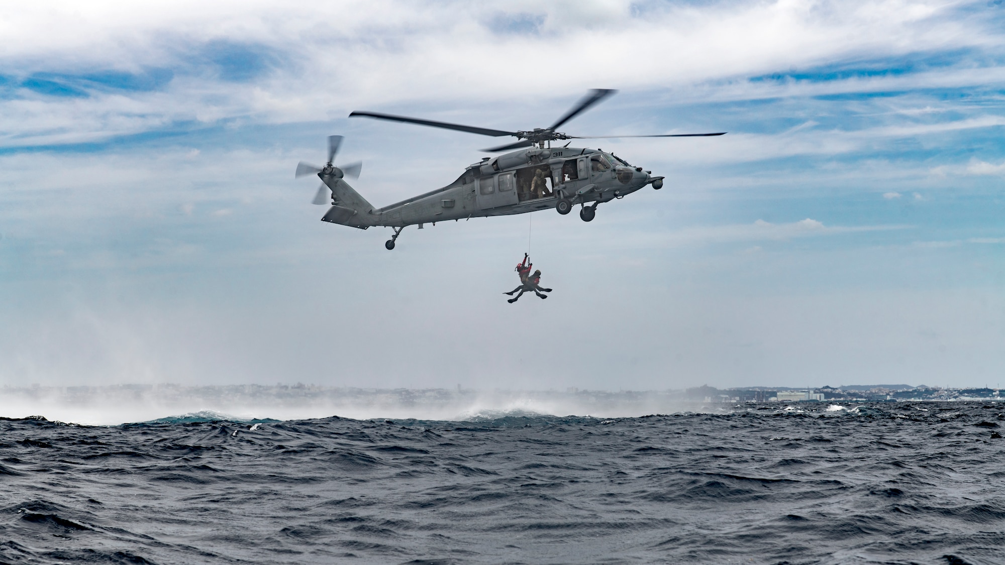 Airmen rappel from a helicopter.