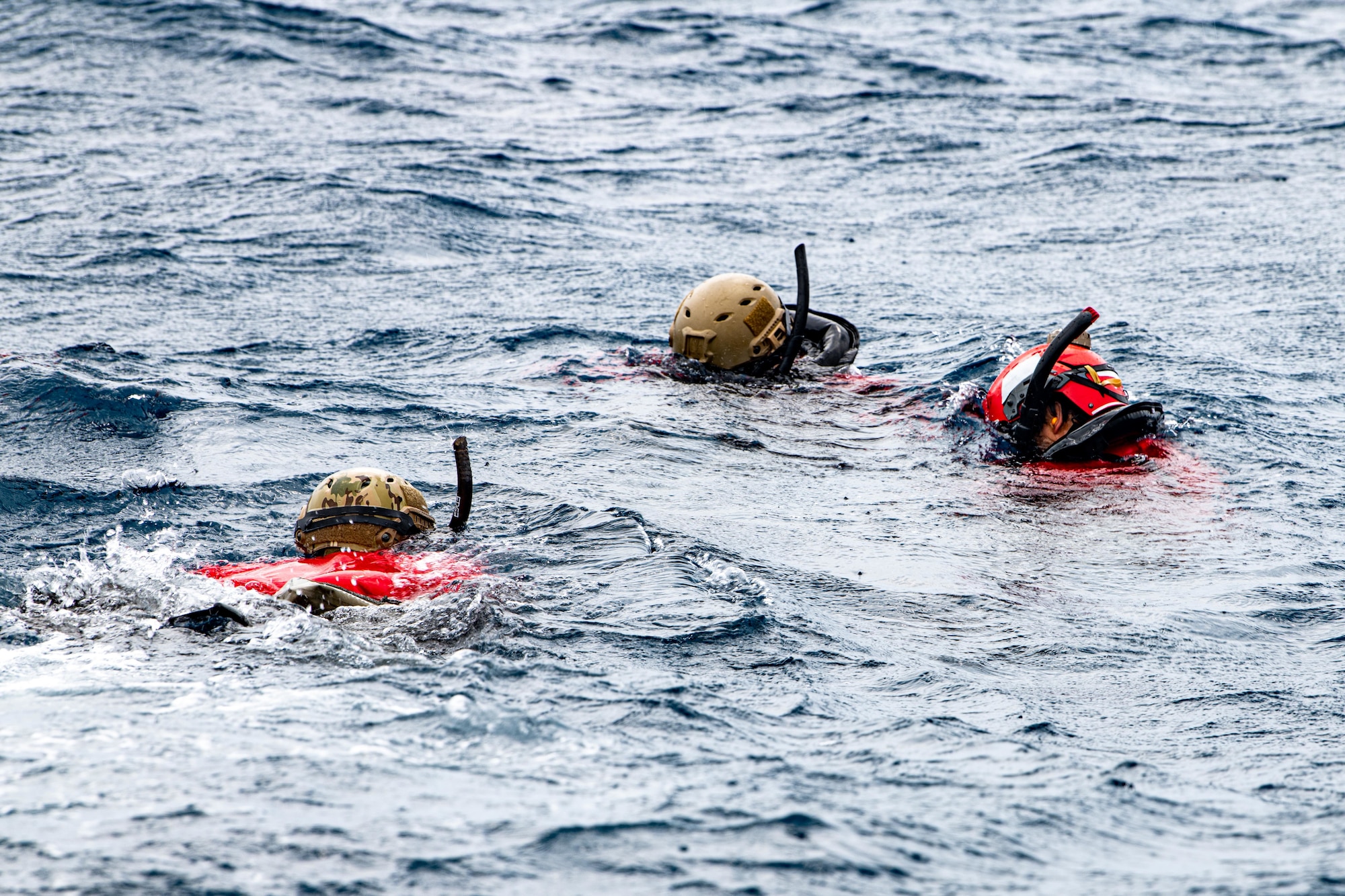 Airmen check gear underwater.