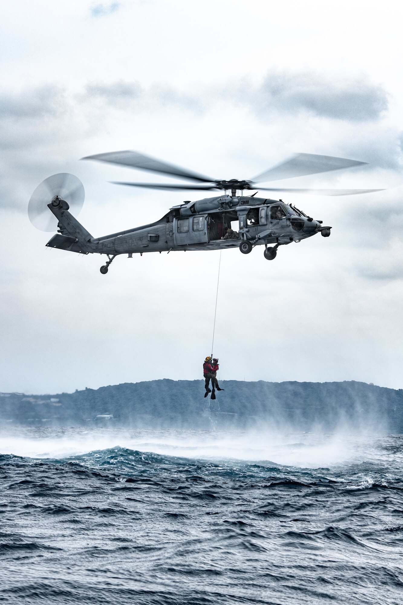 Airmen rappel from a helicopter.