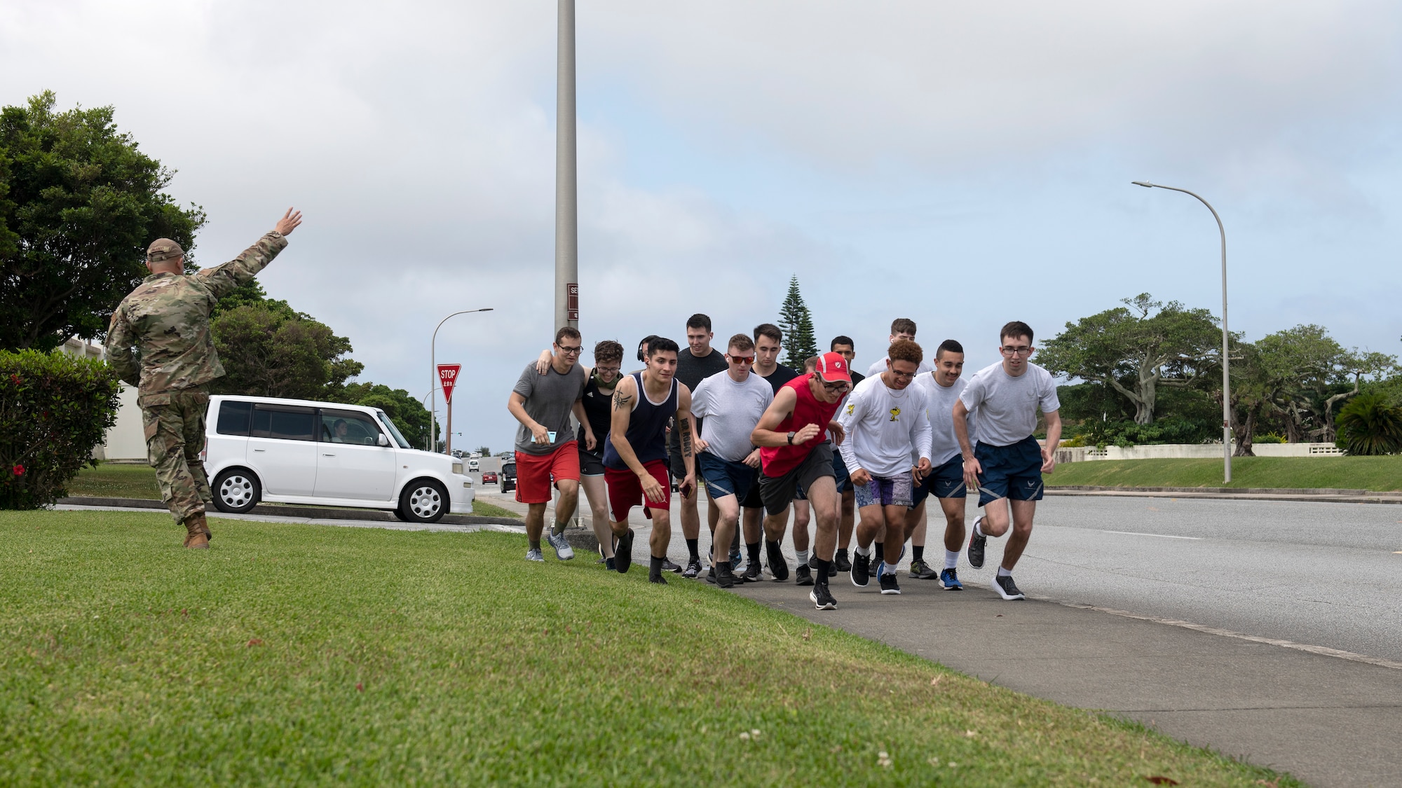 U.S. Air Force Senior Master Sgt. Allen Limjoco gives the signal to start the 5k run during the first annual Dorm Olympics at Kadena Air Base, Japan, April 29, 2022. The event was the brainchild of Airman 1st Class Jaylin Valazquez, 718th Aircraft Maintenance Squadron aerospace propulsion journeyman, who said he wanted to facilitate a way for Airmen from different dorms to get to know each other. (U.S. Air Force photo by Senior Airman Jessi Monte)