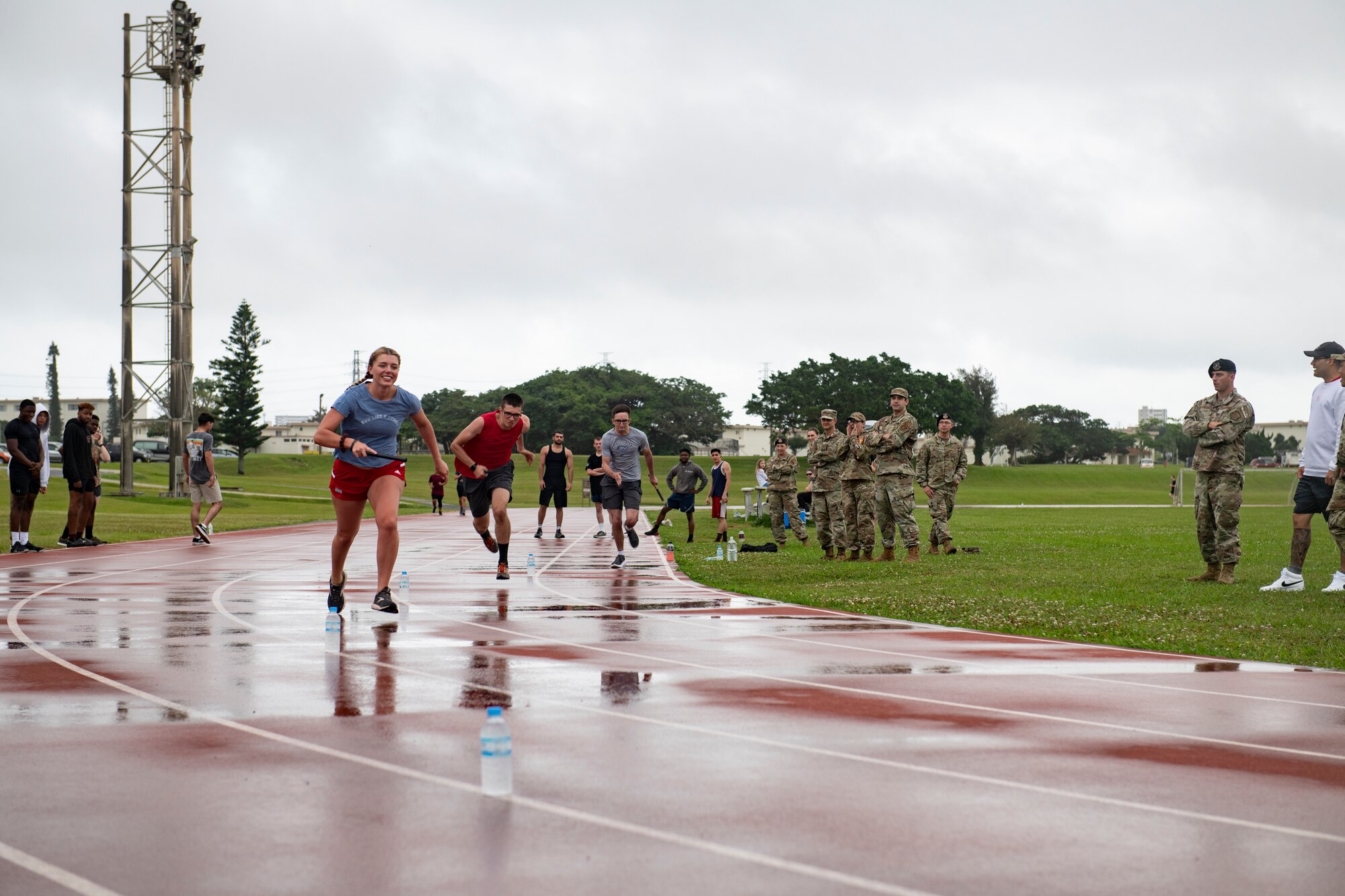 Airmen from the 18th Wing begin a relay race during the first annual Dorm Olympics at Kadena Air Base, Japan, April 29, 2022. Teams of four participated in the relay race, with each member running a full lap around the track before passing the baton to their teammate to take over. (U.S. Air Force photo by Senior Airman Jessi Monte)