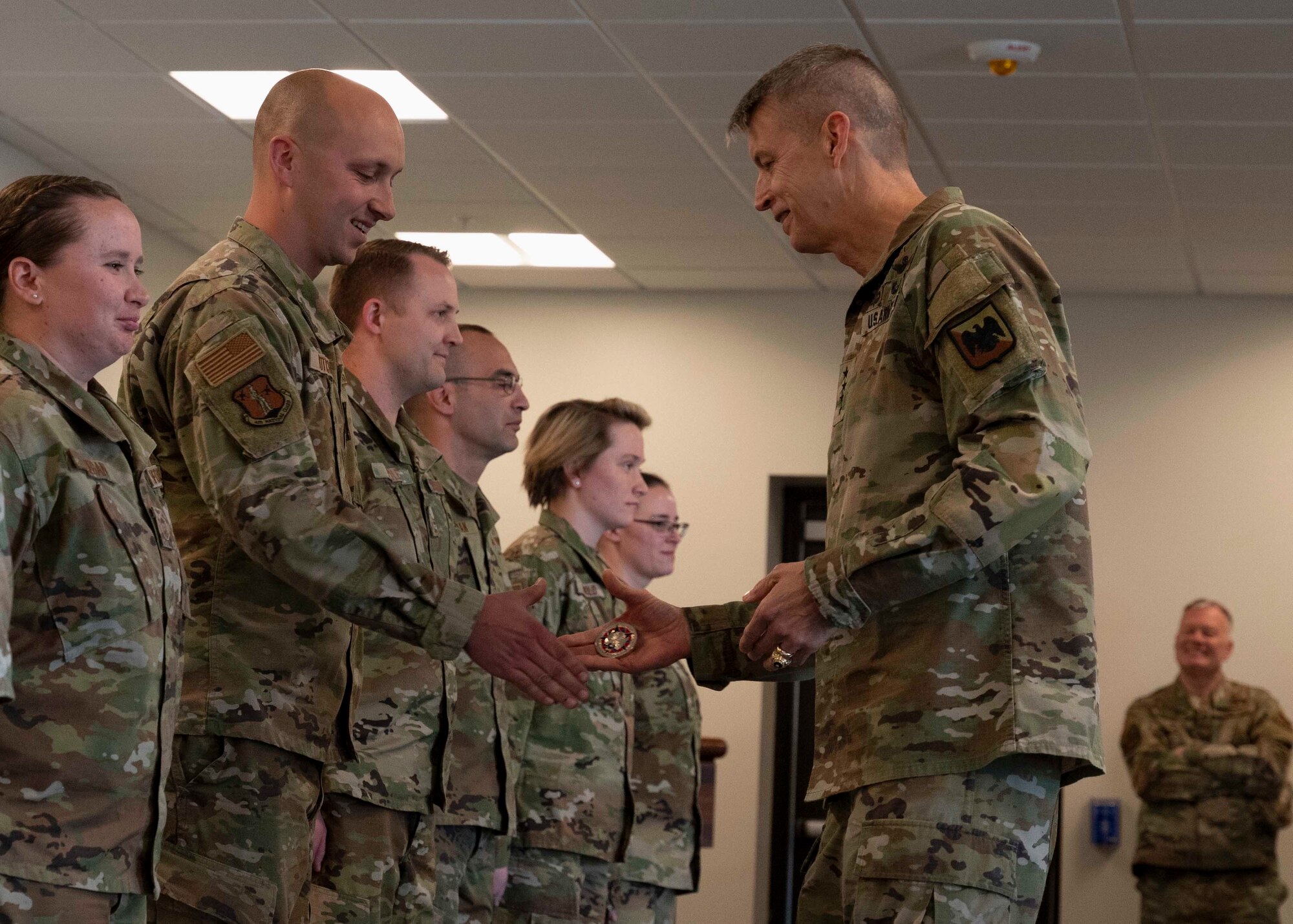 Staff Sgt. Josh Poticha, crew chief with 157th Aircraft Maintenance Squadron, 157th Air Refueling Wing, is coined by visiting Gen. Daniel Hokanson, chief, National Guard Bureau, at Pease Air National Guard Base in Newington, New Hampshire, May 3, 2022. Hokanson also met with adjutants general from 11 states to discuss various strategic initiatives.