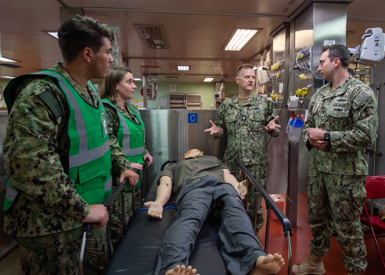 Cmdr. Christopher Martin, a chaplain assigned to the hospital ship USNS Mercy (T-AH 19) (middle right), provides instructions to the religious ministry team aboard the ship, April 12. Mercy can steam to assist anywhere to provide relief as a symbol of Navy Medicine’s abilities around the world, and must be in a five-day-activation status in order to support missions over the horizon, and be ready, reliable and resilient to support mission commanders.(U.S. Navy photo by Mass Communication Specialist Seaman Raphael McCorey)