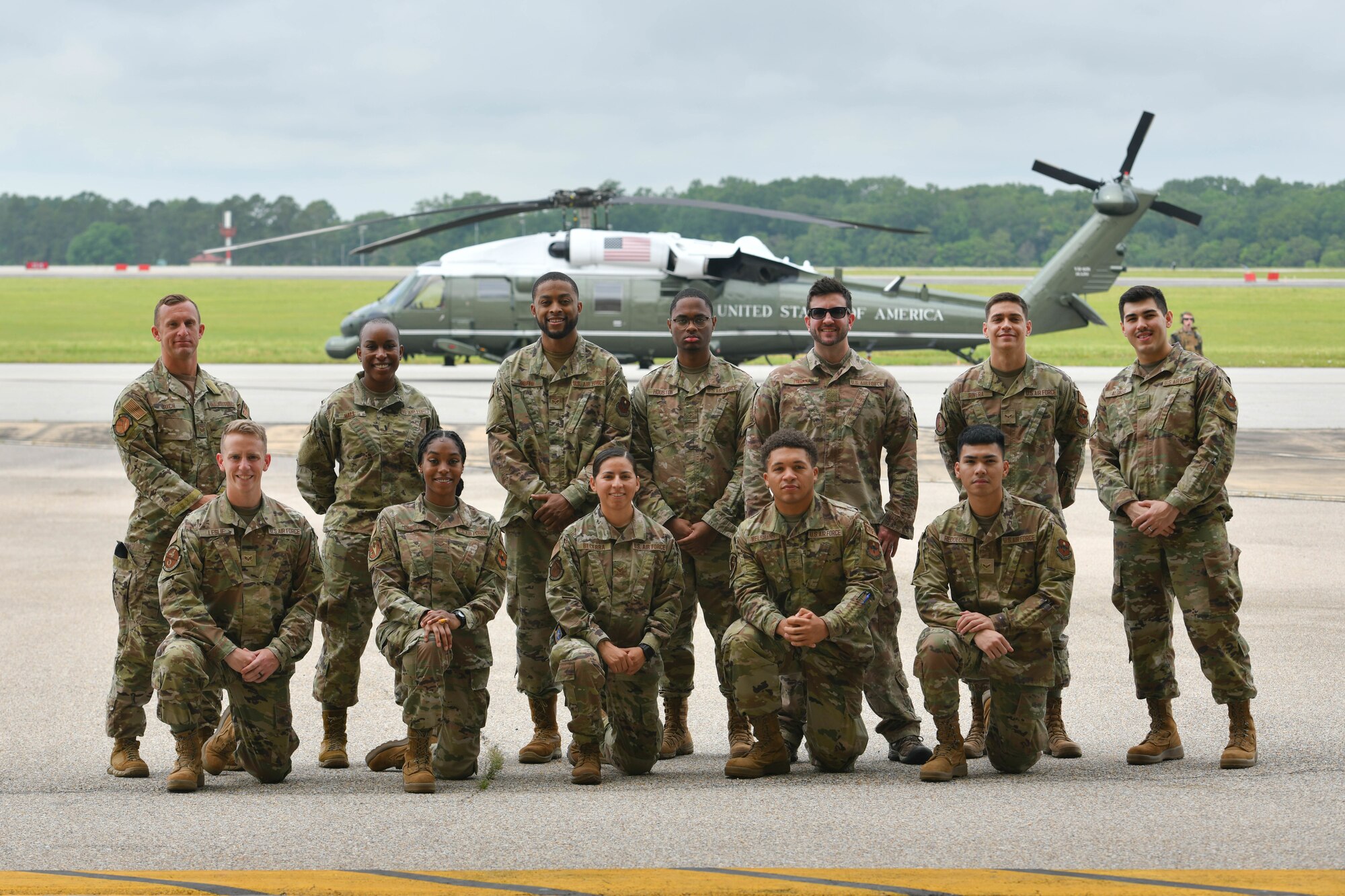 Maxwell-Gunter Airmen pose for a photo in front of a VH-60N "White Hawk" helicopter on Maxwell Air Force Base, Alabama, May 2, 2022. The Airmen were offered an incentive flight for exemplary performance and had the opportunity to ride in a Marine Corps MV-22B "Osprey". (U.S. Air Force photo by Senior Airman Jackson Manske)