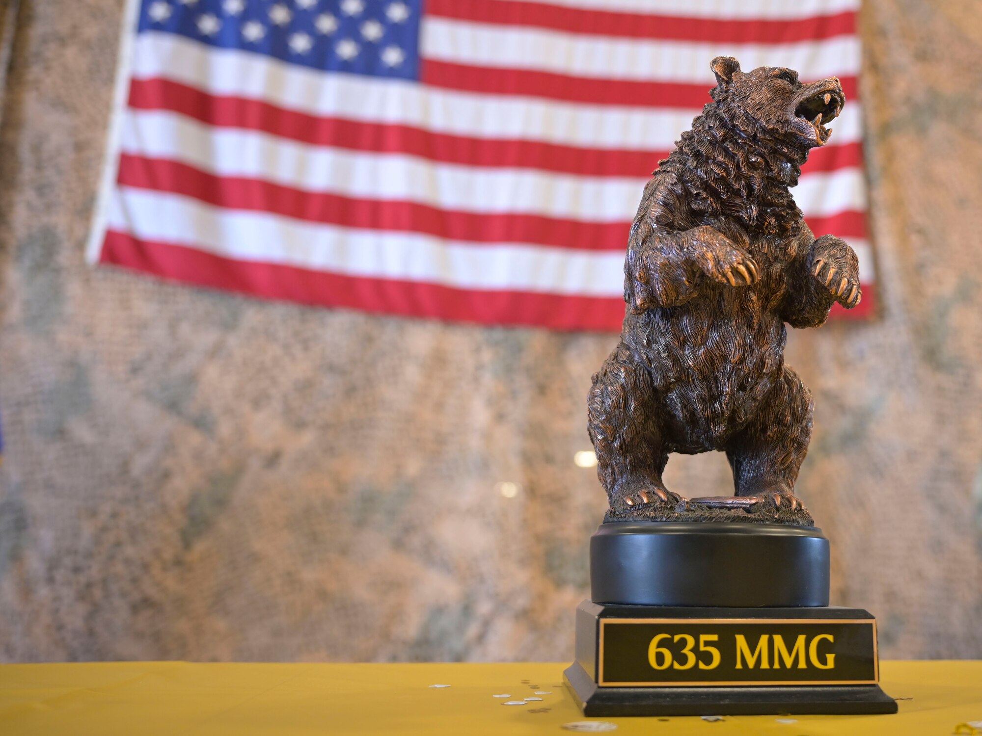 A bear figurine representing the Basic Expeditionary Airfield Resource base stands on a guests table, May 5, 2022, on Holloman Air Force Base, New Mexico. Airman and civilians from BEAR Base celebrated 50 years of providing mission-ready equipment for global power and reach. (U.S. Air Force photo by Airman 1st Class Antonio Salfran)