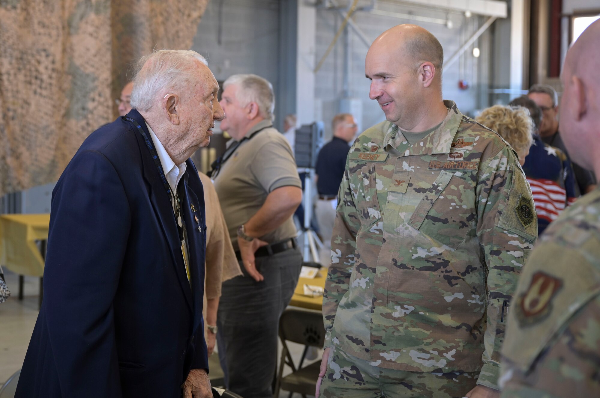 Retired Col. Charles Hartman speaks with Col. Ryan Keeney, the 49th Wing commander, at the Basic Expeditionary Airfield Resources base 50-year anniversary celebration, May 5, 2022, on Holloman Air Force Base, New Mexico. In 1972, Hartman began his tenure as the first commander for the 4449th Mobility Support Squadron, which has since been re-designated as BEAR base. (U.S. Air Force photo by Airman 1st Class Antonio Salfran)